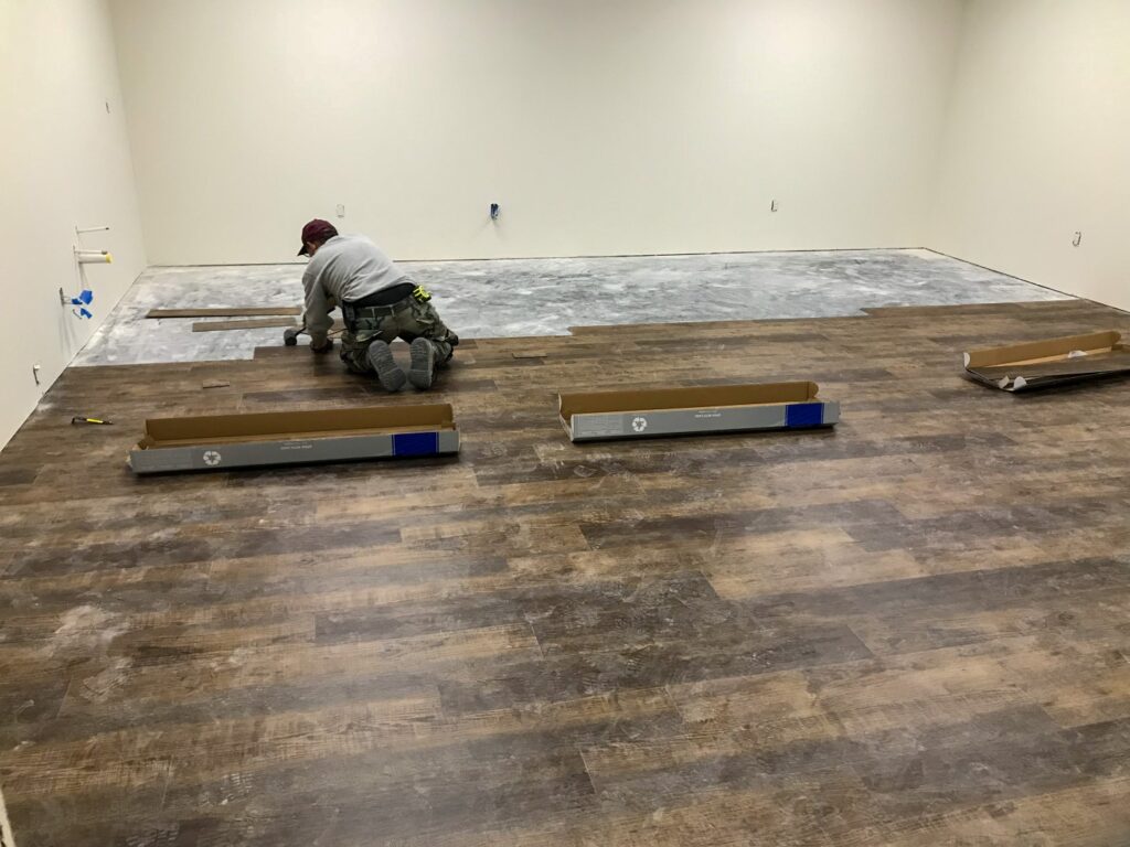 Tile floor repair being completed by a handyman in Leavenworth.