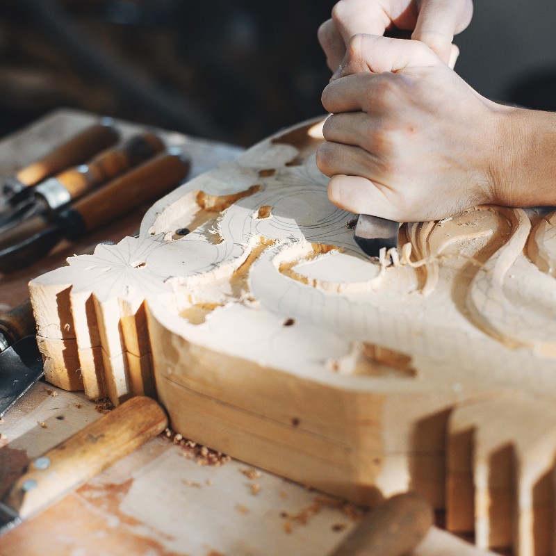 A carpenter carving a wood