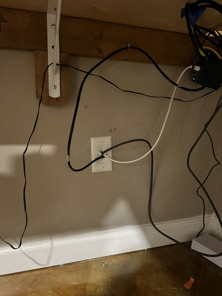 Wall-mounted electrical outlet with wires connected,