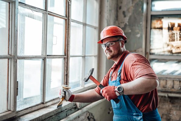 construction worker at work with hammer and chisel